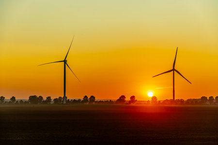 Sunset with a view of a few wind turbines - Germanyの写真素材