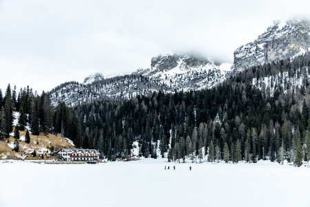 Hike around the snow-covered Lago di Misurina at the gates of the Three Peaks Nature Park - Italyの写真素材