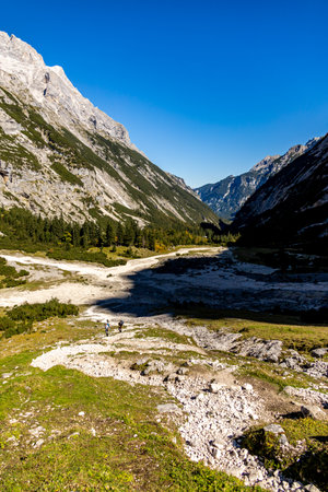 Mountain hike through the beautiful Bavarian Alps just outside Garmisch-Partenkirchen up to the Zugspitze - Bavaria - Germanyの写真素材