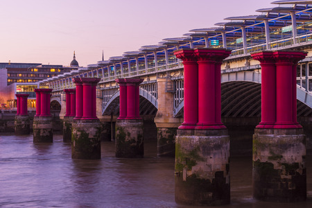 Blackfriars bridge with columns of purple pillars next to itの写真素材