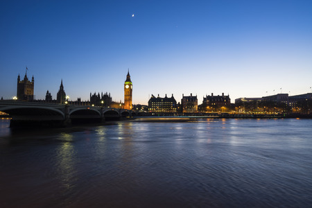 Westminster, the British parliament, and Westminster bridge captured from the South Bank, and a ferry is streaking across the water.のeditorial素材