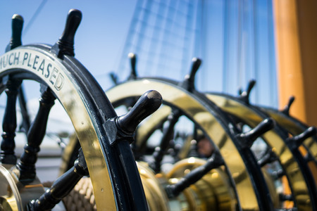 A brass steering wheel of a ship at Portsmouth.の写真素材