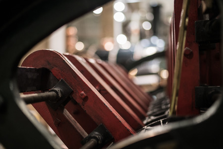 A row of red metal engine parts in shallow focus.の写真素材
