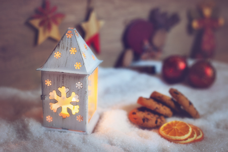 Christmas lantern with light coming out of it and Christmas decorationsの写真素材