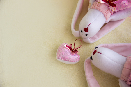 Heart soft toy and toy rabbits on the right. Concept - love.の写真素材