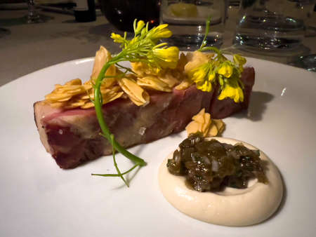 Fine dinning dish - glazed pork belly with young almond, mustard and pickled white grapeの写真素材