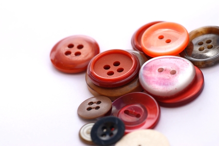 colored sewing buttons on a white background