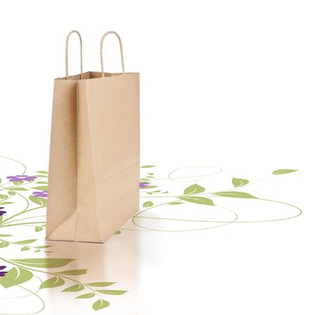 kraft paper shopping bag isolated on a white background with a green floral designの写真素材