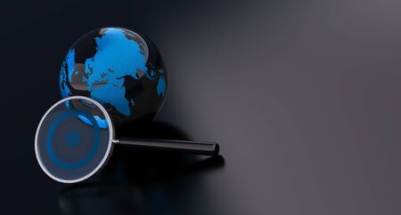 earth and magnifying glass over a black backgroundの写真素材
