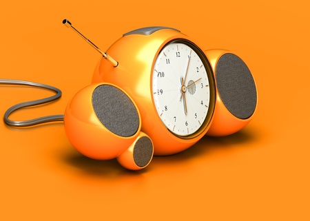 vintage orange alarm clock with sound speakers and antenna over orange backgroundの写真素材