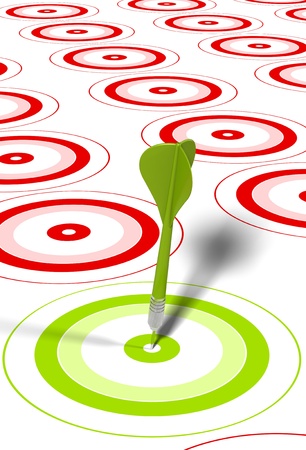 green dart hitting the center of a red target, there is some red targets around の写真素材