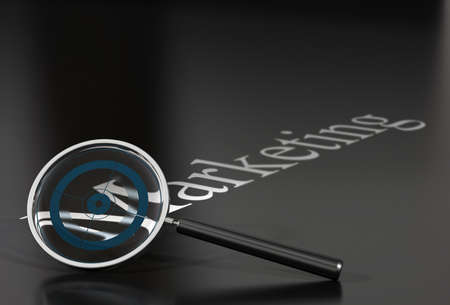 marketing word over a black background withe a magnifying glass and a blue target insideの写真素材