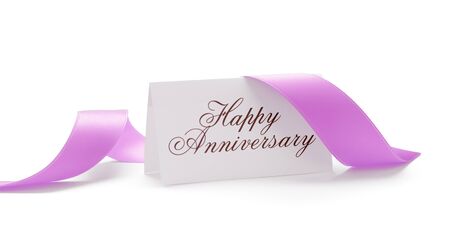 Happy anniversary card with a pink ribbon over a white backgroundの写真素材