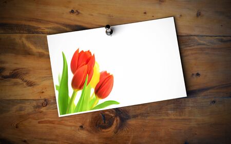 Empty Love card with tulip flowers fixed onto a wooden wall with thumbtackの写真素材