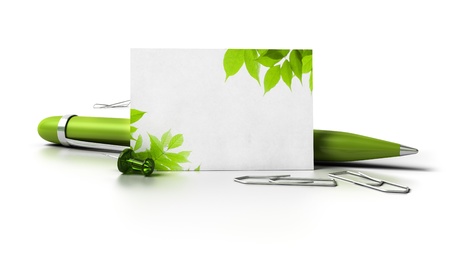 blank business card with leaves at the corner, ballpoint pen thumbtack and paperclips over a white background with reflection の写真素材