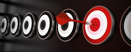 many targets over a black background with reflection, a red dart hit the center of one red target, horizontal banner styleの写真素材