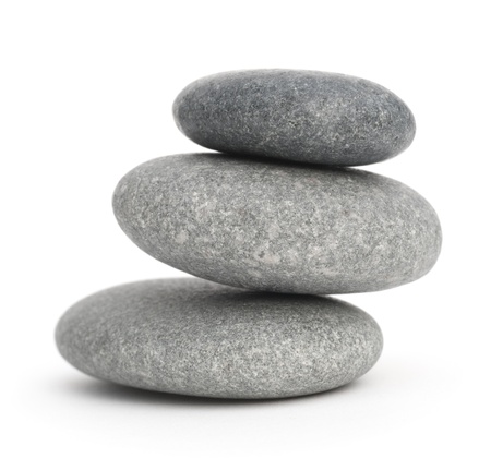three pebbles stacked one onto each other, 3 stones over white backgroundの写真素材
