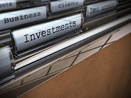 focus on the word investment written onto a folder with the word business on the background, blur effect and room for text at the bottomの写真素材