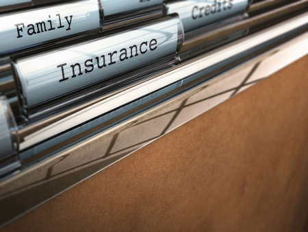 focus on the word insurance written onto a folder with the word family on the background, blur effect and room for text at the bottomの写真素材