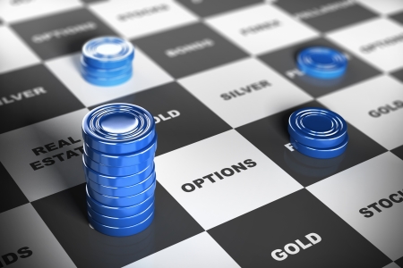 Blue checkers pieces over a financial board where it is written some investment words  Financial concept の写真素材