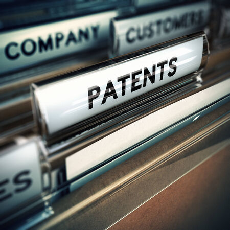 Folder and focus on a tab with the word patents, blur effect  Concept of company innovation   の写真素材
