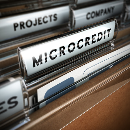 Folder with focus on a tab and the word microcredit, blur effect  Concept of company projects funding   の写真素材