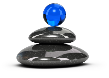 Two black pebbles stacked over white background with a blue glass sphere at the top. Conceptual 3D symbol of wellbeing or harmony.の写真素材