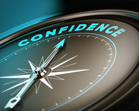 Compass with needle pointing the word confidence, self esteem concept with blue and brown tones  Focus on the top の写真素材