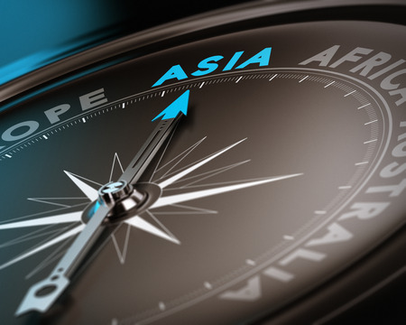 Abstract compass needle pointing the destination asia, blue and brown tones with focus on the main word  Concept image suitable for illustration of trip counseling の写真素材