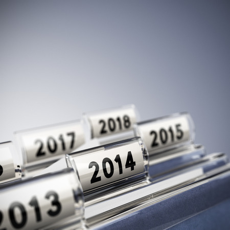 Folder tab with focus on 2014, blue background  Taxes concept for illustration of mid-term or long-term business strategy の写真素材