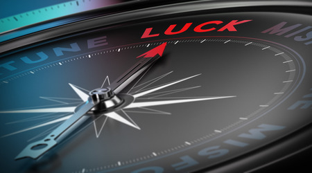 Lucky concept, Compass needle pointing the  word luck over black background, blur effectの写真素材