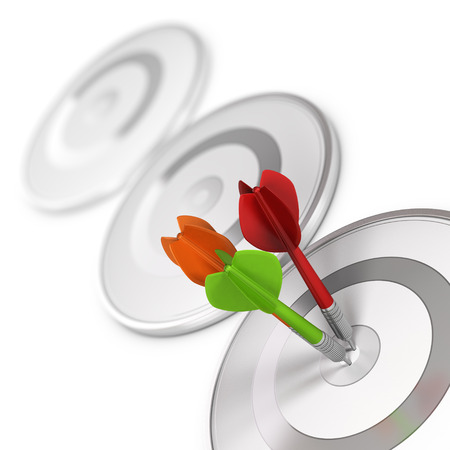 Three darts hitting the center of a modern dartboard, target concept to illustrate high precision or accuracy.の写真素材