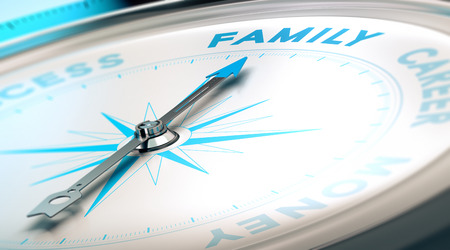 Psychology concept, family vs career. Compass pointing the word family, blue and beige tones.の写真素材