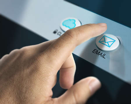 One finger pressing an email button to check for emails, concept of communication or mailbox.の写真素材