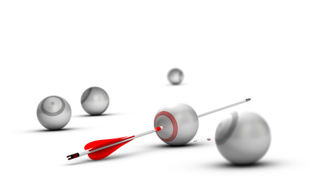 Concept image for illustration of setting goals and achieve them. Sphere targets over white background with one arrow hitting the center of the red oneの写真素材