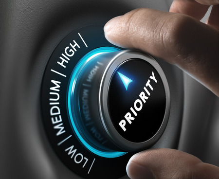 Man fingers setting priority button on highest position. Concept image for illustration of priorities management.の写真素材