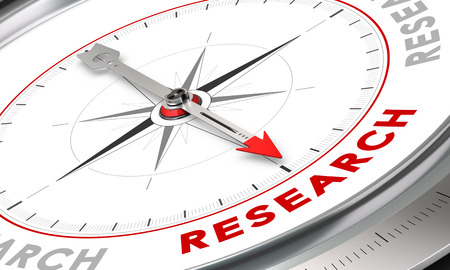 Compass with needle pointing the word research. Conceptual illustration for cognition development and inovation.の写真素材
