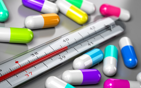 thermometer with many pills around it over grey background. Concept image for illustration of over consumption of drugs and antibiotics.の写真素材