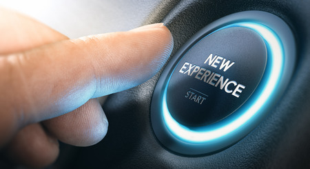 Finger about to press a push button with the message new experience start. Leaving comfort zone and starting new life concept.の写真素材