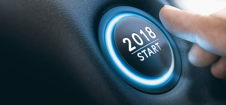 Finger pressing a 2018 start button. Concept of new year, two thousand eighteen. Composite between a photography and a 3D background. Horizontal image Finger pressing a 2018 start button. Concept of new year, two thousand eighteen. Composite between a photography and a 3D background. Horizontal image