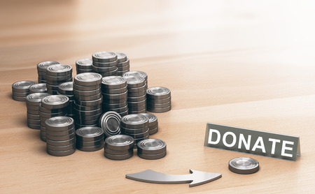 Piles of coins symbols on a wooden table and an arrow pointing a single coin with the word donate. Donation concept. 3d illustration.の写真素材