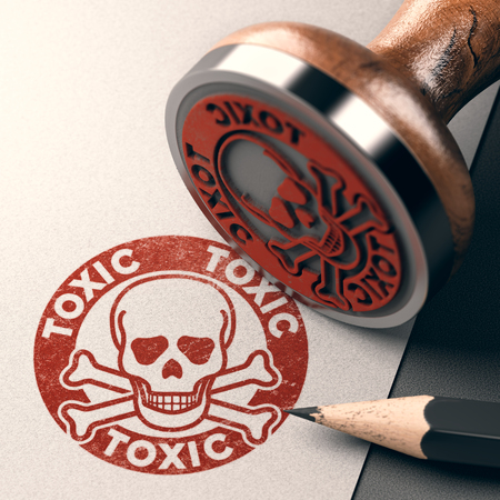 3D illustration of a rubber stamp with skull, bones and the text toxic stamped on paper backgroundの写真素材