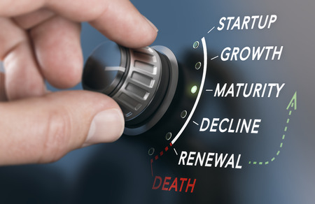 Hand turning a business life cycle switch with six different phases. Composite image between a hand photography and a 3D background.の写真素材