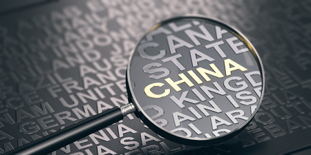 3D illustration of a magnifying glass over black background and focus on China. Emerging Markets concept.の写真素材