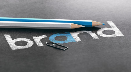 Brand name written over black paper background with white and blue wooden colored pencils. 3D illustrationの写真素材