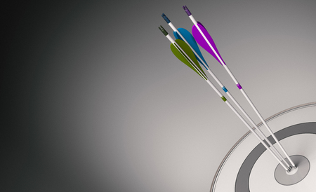 Three arrows with different colors hitting the center of a modern target, concept of team cohesiveness. 3D illustrationの写真素材