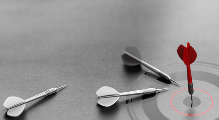 3D illustration of a red dart reaching the center of a target over grey background and other one failed to achieve goal. Concept of business or corporate success.の写真素材