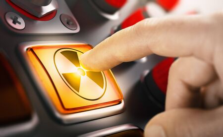 Finger pushing a nuclear button. Concept of uranium enrichment and radioactivity. Composite image...