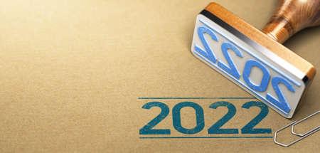 Rubber stamp with the year 2022 printed on a brown paper background with copyspace on the left side.の写真素材