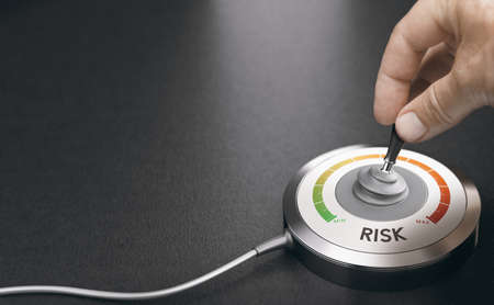 Man hand using a conceptual joystick over black background to monitor risk and make a risky choice....